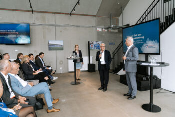 Zwei Männder stehen auf der Bühne und sprechen